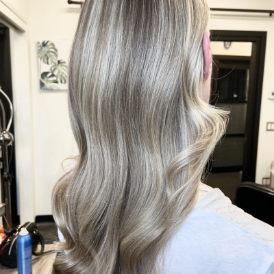 Sleek Hollywood waves in platinum silver blonde, showcasing glossy finish and modern bridal hair styling